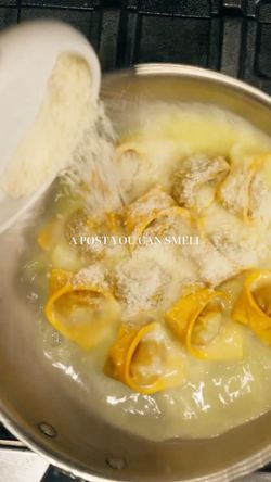 Fresh pasta boiling in a pot with grated cheese being added at Sparrow Italia Miami Italian restaurant.